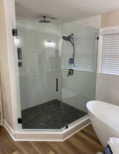 frameless glass shower enclosure with white walls